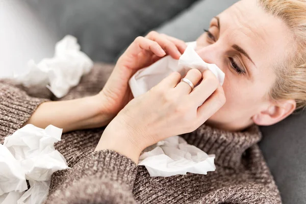 Woman sick in the bed, flu and virus infections, allergy, seasonal health issues.