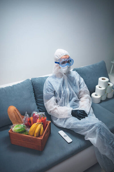 Quarantine and isolation during the virus outbreak - groceries and food in stock, sitting at home, panic, anxious behaviour.