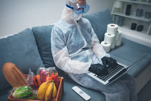 Quarantine and isolation during the virus outbreak - groceries and food in stock, working from home over the internet.