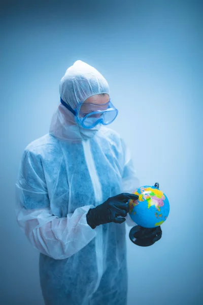 Medical doctor and scientist holding Earth globe for presenting virus pandemic outbreak on the whole planet.