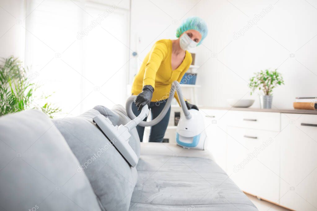 Home, apartment and room sterilization, cleaning, vacuuming with vacuum cleaner in the time of dangerous viruses.