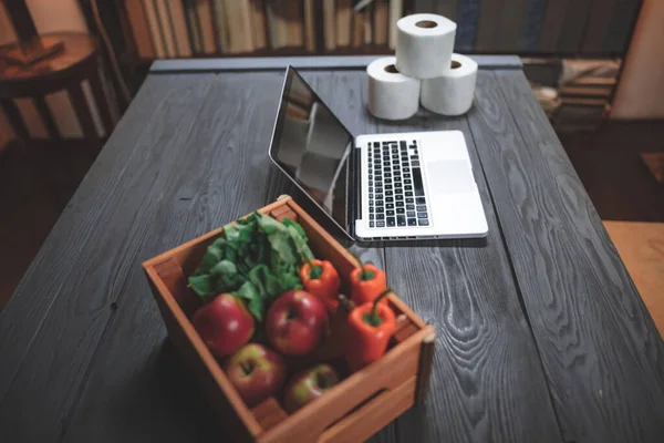 Food, groceries, toilet paper and laptop for shopping online in the time of panic viral pandemics.