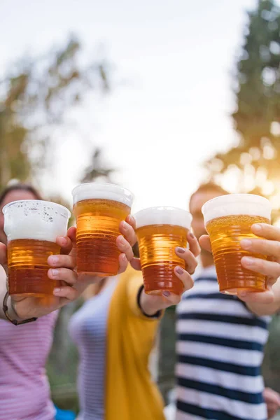 Friends enjoying drinking beer in the backyard.