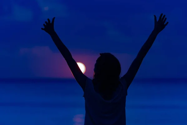 Woman with arms wide open enjoying ocean tropical time.