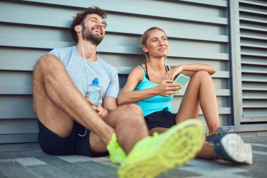 Modern çift koşu / egzersiz sırasında kaldırımda mola veriyor.