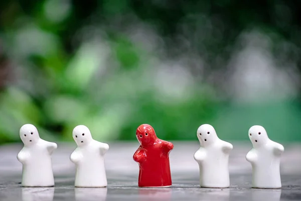 Vier witte keramische poppen Maar er is een rode, groene achtergrond — Stockfoto