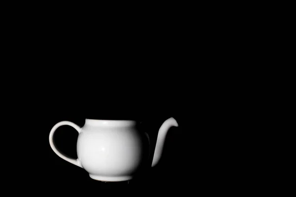 Photo of a white ceramic kettle with shadows from light and a bl — Stock Photo, Image