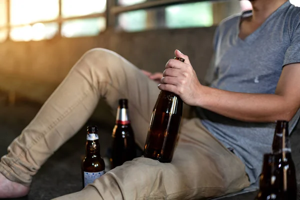 Portrait of a drunken man holding a bottle in front of him — 스톡 사진