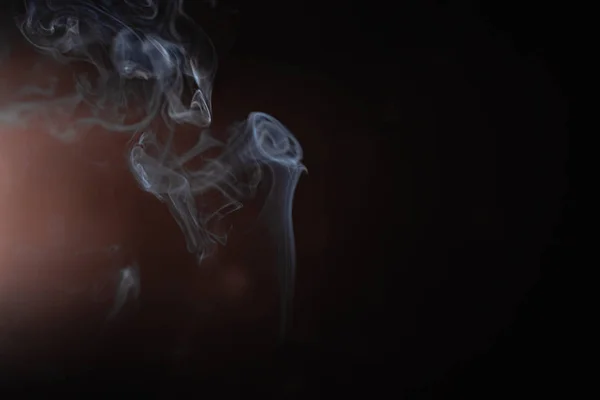 Abstract smoke from incense and light in a black background — Stock Photo, Image