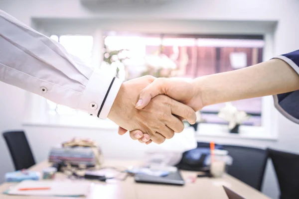 Business people shake hands to finish the meeting , Hand in hand to work together