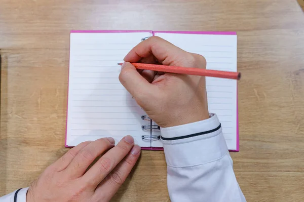 ペンを持ってノートにメモをとる営業者の写真 — ストック写真