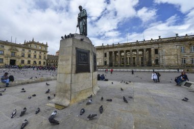 Bogota, Colombia - August 24: People in the Bolivar square next to the statue of Simon Bolivar and the National Capitol in the background on August 24, 2017 in Bogota, Colombia. clipart