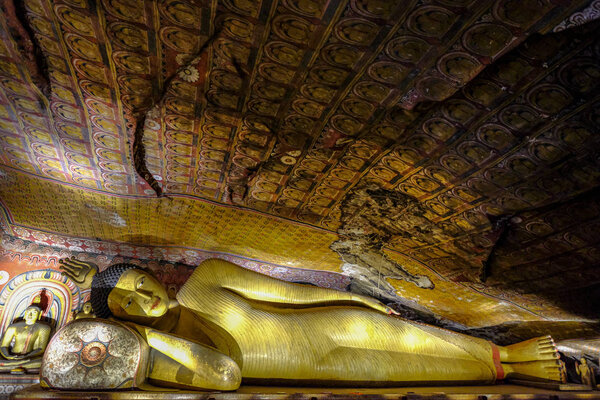 Dambulla, Sri Lanka - February 2020: Buddha statue inside Dambulla cave temple on February 8, 2020 in Dambulla, Sri Lanka. Cave III Maha Alut Viharaya. Major attractions are spread over 5 caves, which contain statues and paintings.