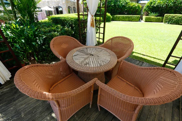 Rattan garden furniture in a gazebo on the garden