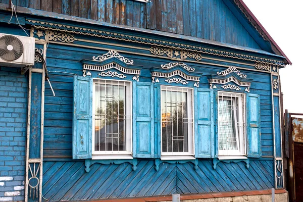 facade of an old wooden house in a Russian village with carved windows and shutters built in the national Russian style