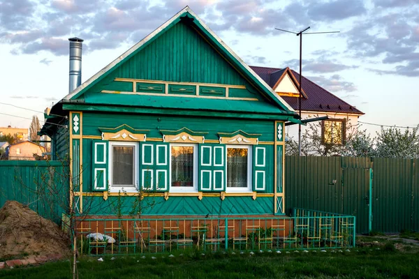 facade of an old wooden house in a Russian village with carved windows and shutters built in the national Russian style