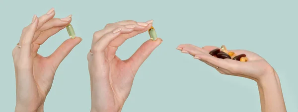 Omega 3 capsules and vitamin supplements on the human hand set isolated on blue background