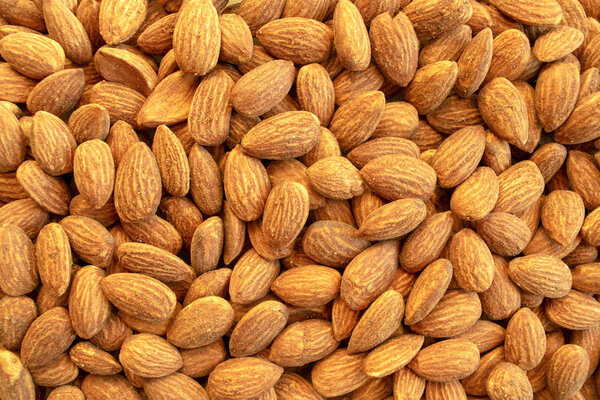 Background of almond nuts. Healthy snack and food. Salted and roasted bbq almonds. Top view. 