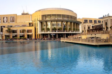 Dubai / UAE - November 5, 2019: World's largest shopping center. Dubai shopping mall exterior with tourists.  Dubai mall modern architecture crowded.