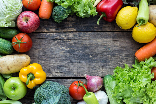 Top view of fruits and vegetables on the old wood table With copy space