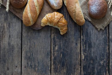Eski ahşap masa zemininde farklı pişmiş ekmek türleri