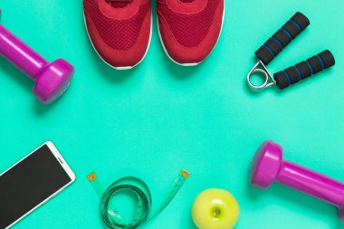 Spor ayakkabısı, elma ve yeşil üzerine akıllı telefon.