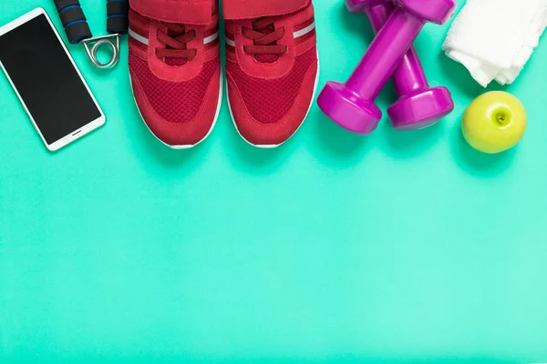 Fitness-Konzept, Turnschuhe, Apfel und Smartphone auf Grün — Stockfoto