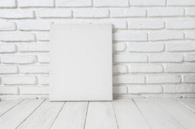 Tahta bir masanın üzerine boş beyaz bez çerçeve