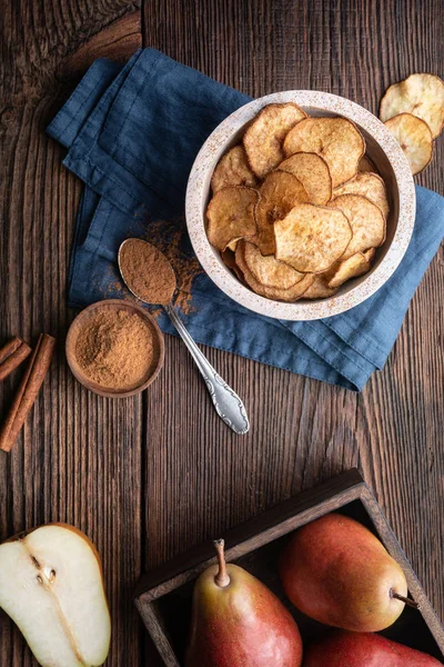 Sött läckert mellanmål, hemlagad ugn torkad krispiga päron chips strös med kanel — Stockfoto