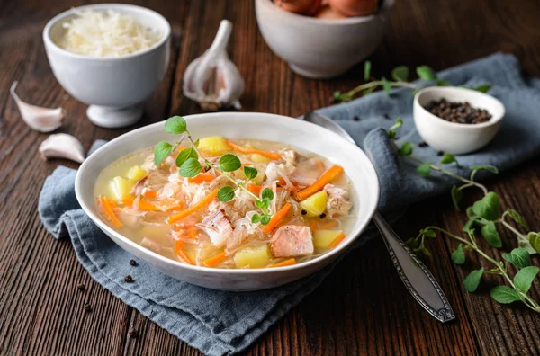 Kapusniak, classic Polish soup made from sauerkraut, pork ribs, smoked bacon, potato, carrot and other vegetable