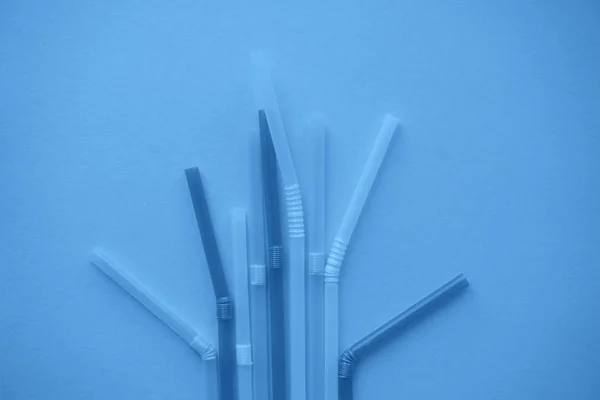 Single-use plastic straws in trendy blue colour.