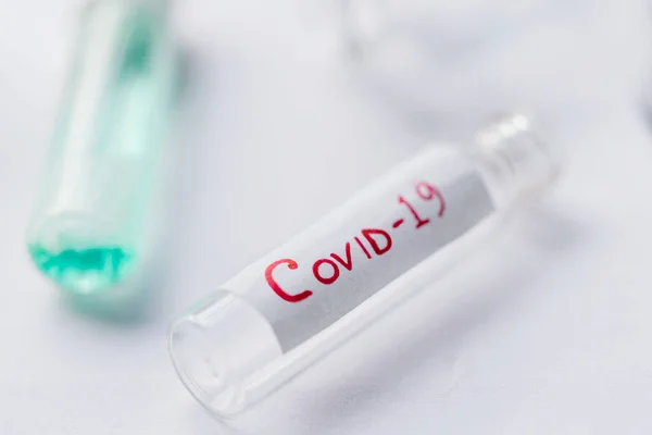 Corona Virus Lab test background. Glass vile or test tube for collecting blood sample of covid-19 infected patients. Concept for pandemic medical health risk, vaccine development.
