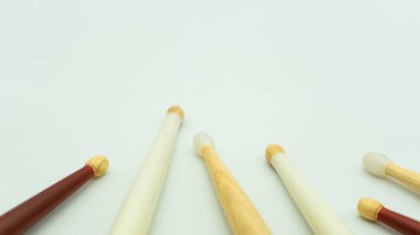 Close up view of wooden drumsticks on white background. Musical instrument concept.