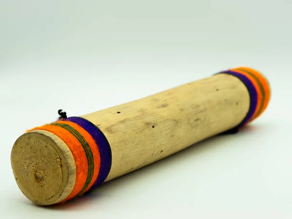 Close up view of handmade wooden rain sticks on a white background. Peruvian instrument. Ambient sound. Concept percussion instruments.