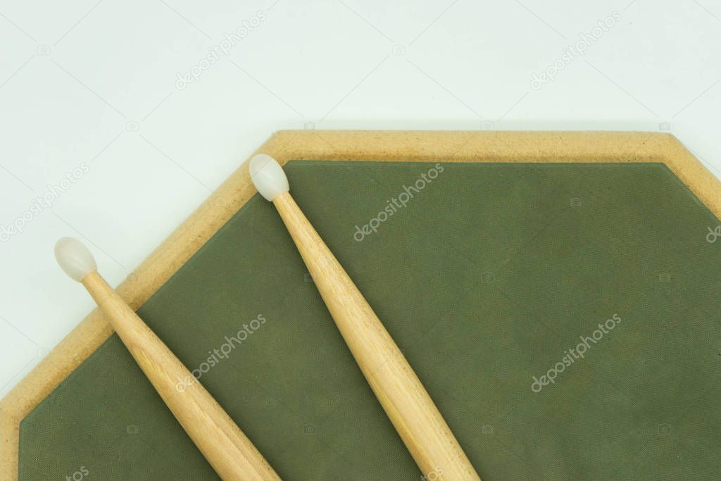 Top view of wooden drumsticks on practice pad. Musical instruments concept.