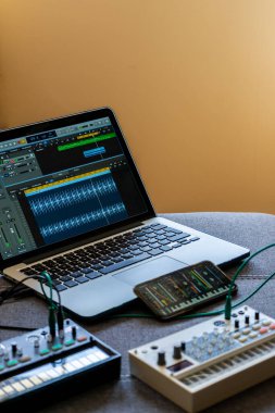 FM synthesizer, örnekleyici, modüler sentezleyicili akıllı telefon ve açık ses editörü Elektronik müzik konseptli laptop 'u kapat. Dikey resim.