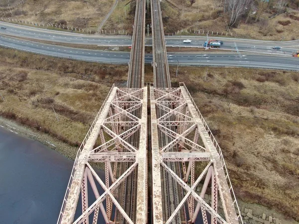 Aerial view panorama of the railway bridge over the river. Beautiful natural landscape with drone