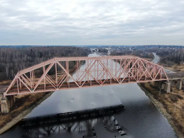 Aerial view panorama of the railway bridge over the river. Beautiful natural landscape with drone