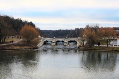 Ancient bridge in Moscow city park in autumn. Beautiful landscape of the historical monument