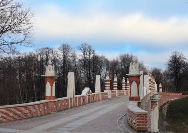 Ancient bridge in Moscow city park in autumn. Beautiful landscape of the historical monument