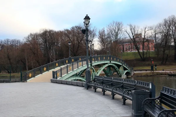 Ancient bridge in Moscow city park in autumn. Beautiful landscape of the historical monument