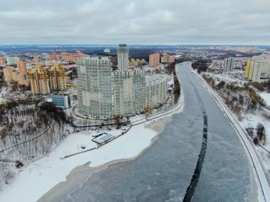Aerial view beautiful urban landscape railway bridge over freezing river from drone