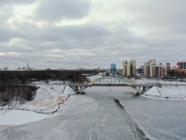 Aerial view beautiful urban landscape railway bridge over freezing river from drone