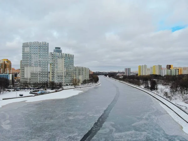 Aerial view beautiful urban landscape railway bridge over freezing river from drone