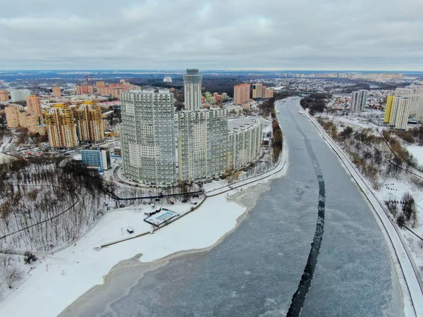 Aerial view beautiful urban landscape railway bridge over freezing river from drone