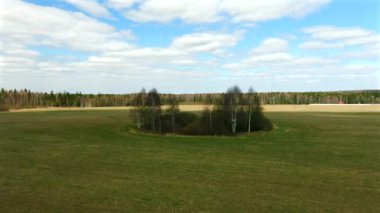 Büyük eğimli bir arazide yeşil bir adanın üzerinde uçuyor. Yukarıdan dron görüntüsünden panoramik manzaranın bir resmi