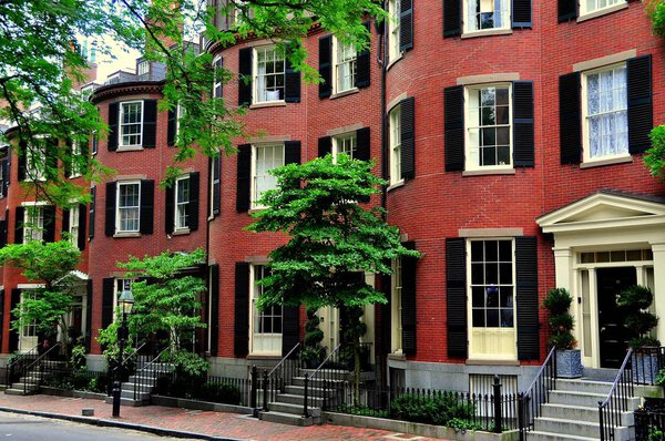 Boston, Massachusetts - July 14, 2013: 19th century brick homes with front curved bays Beacon Hill's historic Louisburg Square