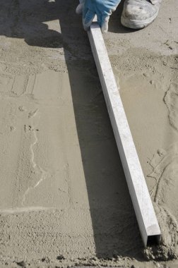 bir çatı yenileme için bir bina yerinde çimento atar işçi