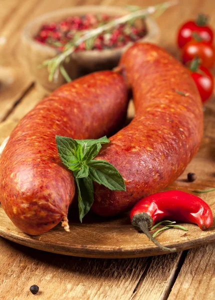 Raw sausages on wooden background — Stock Photo, Image