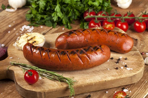 Grilled sausages on wooden background — Stock Photo, Image